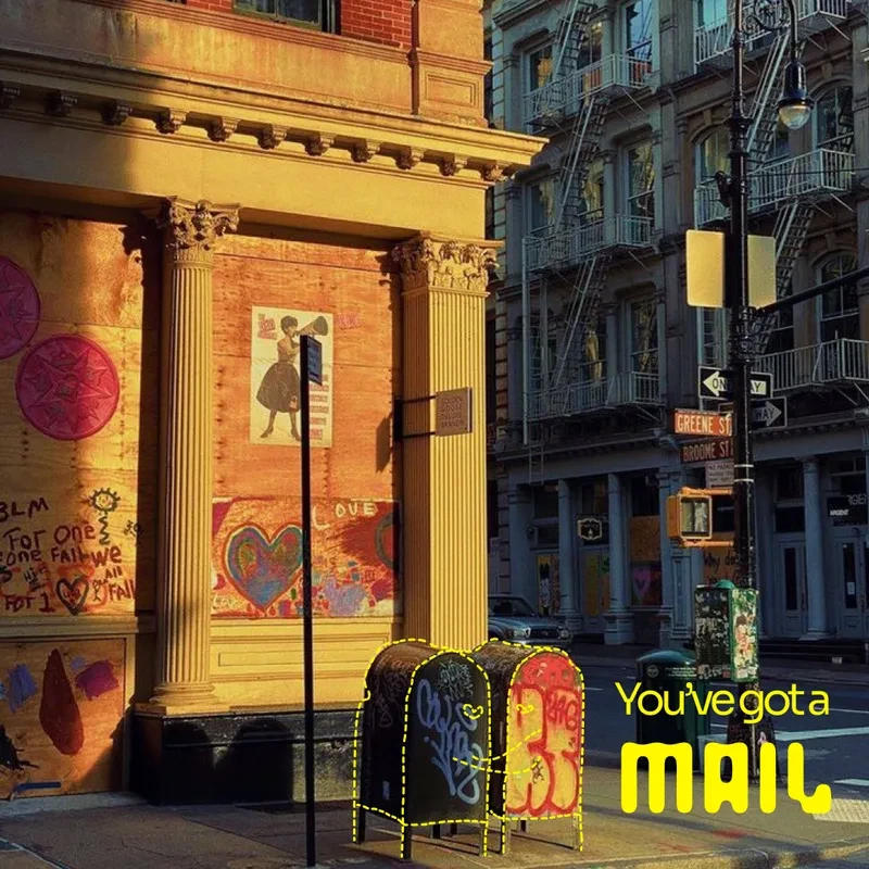 'You've got a MAIL' in yellow over a photograph of a New York street corner, with the mailboxes outlined in the same yellow.